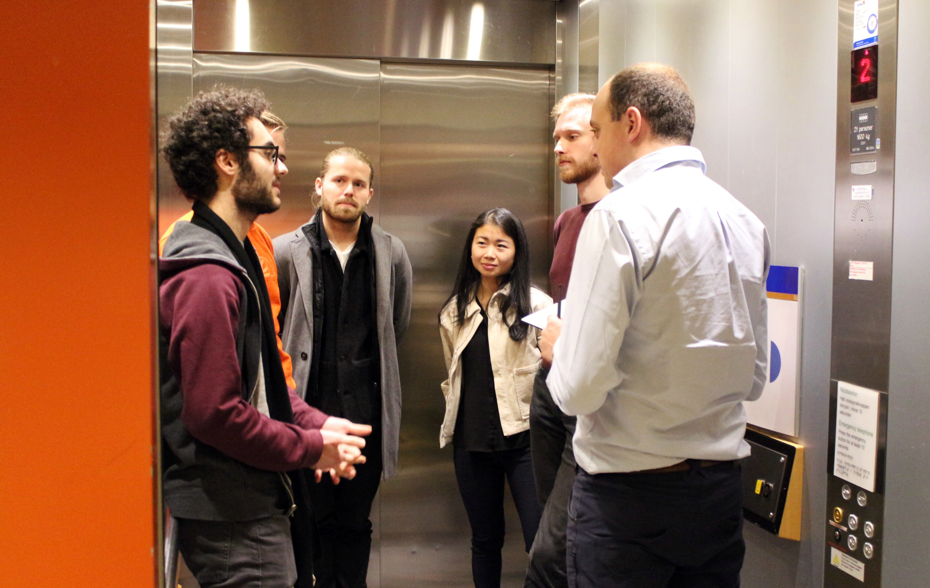 Photo of people in an elevator.