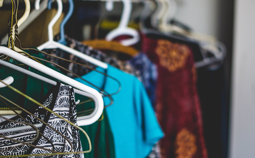 Clothes hanging on hangers. Photo.