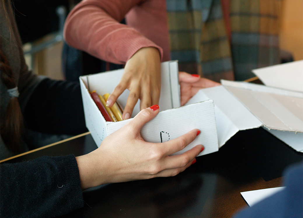 hands handling packaging prototypes. photo. 
