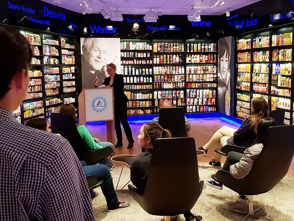 Photo of students in a display room for packaging.