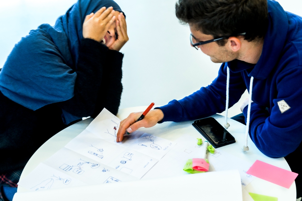 two students laughing and working. Photo. 